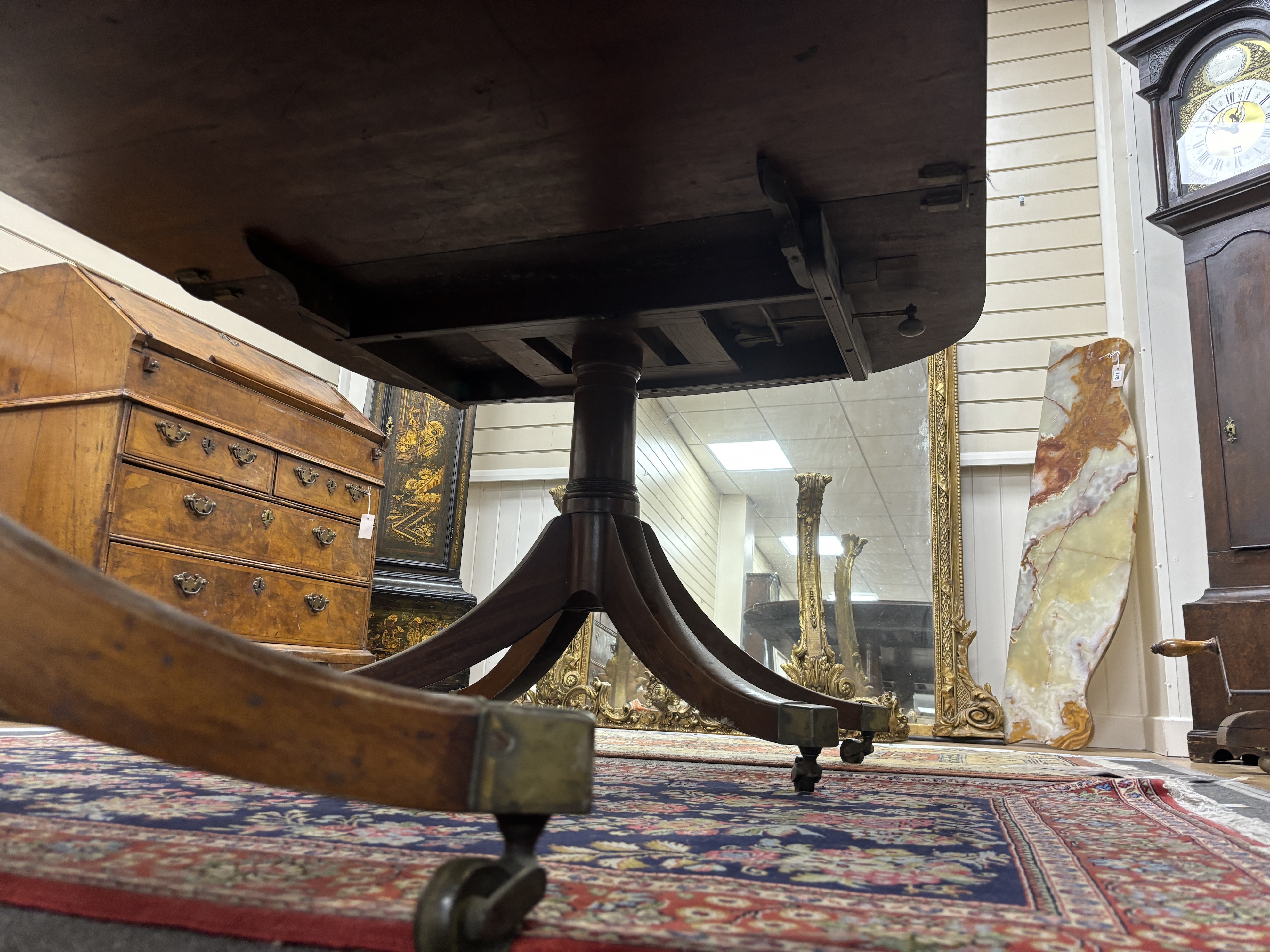 A Regency mahogany twin pillar extending dining table, 208cm extended, one spare leaf (with one other leaf but lacks extension bars, depth 116cm, height 71cm